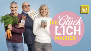 Das hr1-Team steht vor einem blauen Hintergrund, daneben steht "Die Glücklichmacher".