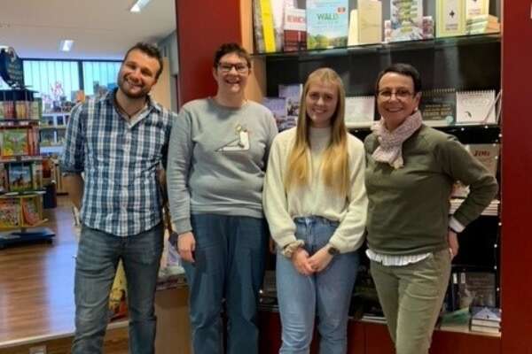 Ein Mann und drei Frauen stehen vor einem Bücherregal in der Buchhandlung Bücher König in Neunkirchen.